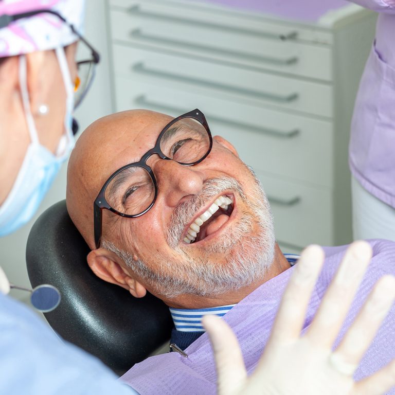 Smiling older man relaxing in a dental chair